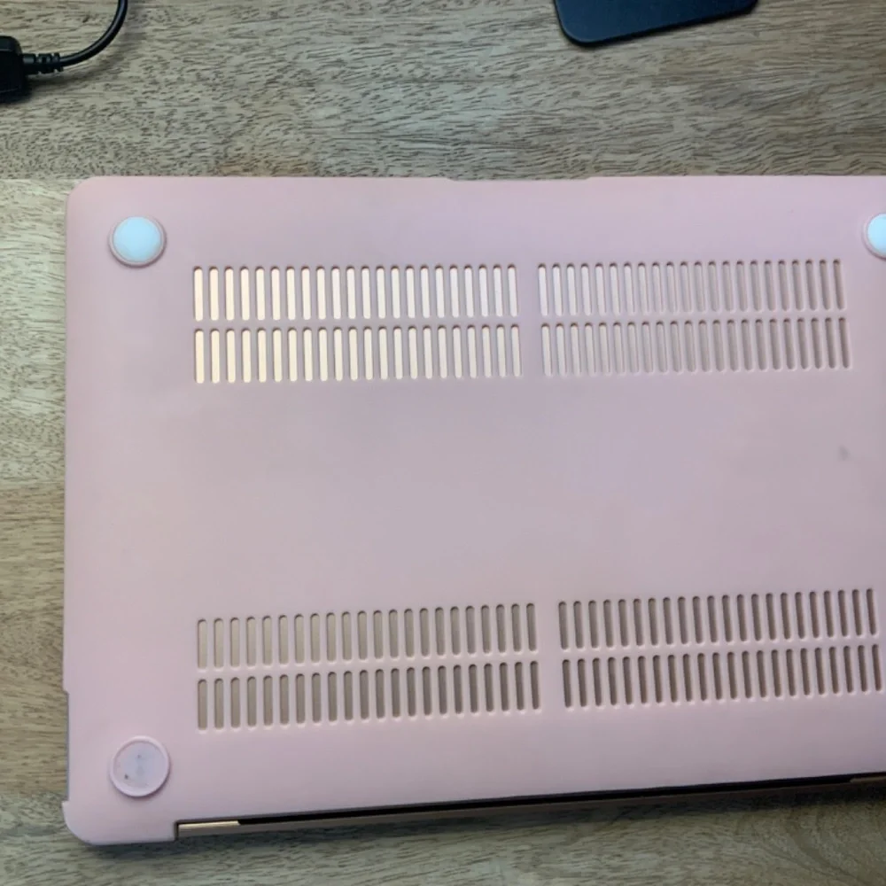 Pink MacBook with pink case and Apple mouse